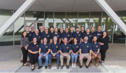 Photo of a group of people posing together.
