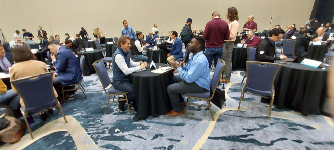 Kwaku Jyamfi sits and speaks with an investor