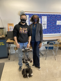 Cochran Hameen standing with a student