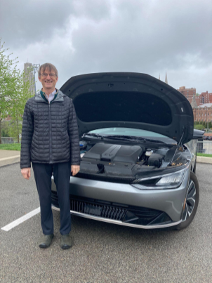 Anthony Rollett standing next to his Kia EV6