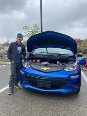 Chris Gassman standing next to  his Chevy Bolt.