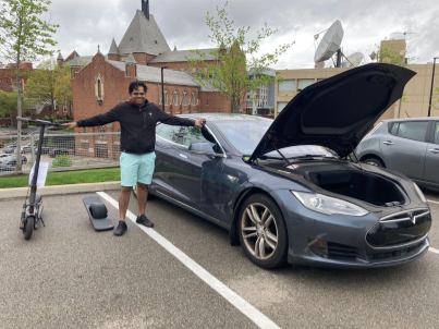 Venkat Viswanathan with his Tesla Model S, his electric scooter, and electric one-wheeler.