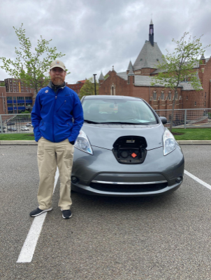 Steven Guenther with his Nissan Leaf.