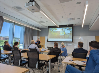 The German delegation listens to a talk by Daniel Tkacik