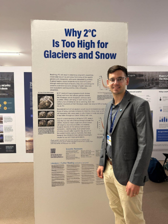David Rounce stands at his poster, titled "Why 2˚C Is Too High for Glaciers and Snow"