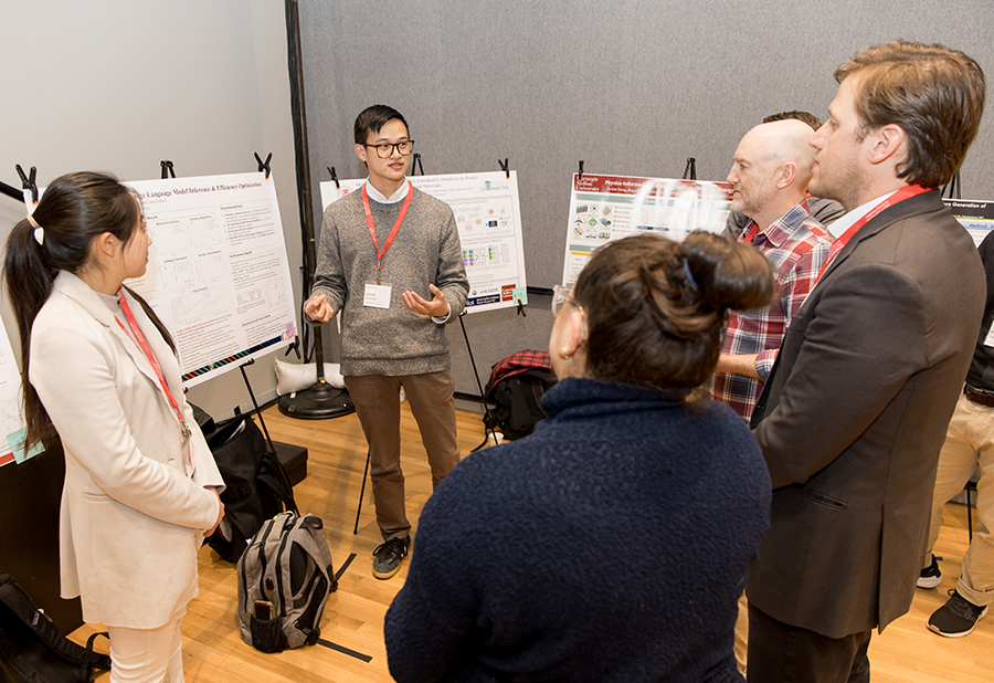 Presenters and judges talk during the poster competition.